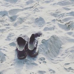 High angle view of shoes on beach