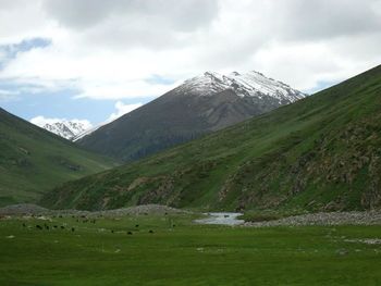 Scenic view of landscape against cloudy sky