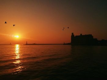 View of sea against orange sky