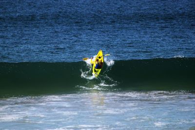 Man kayaking on sea