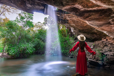 Scenic view of waterfall against rocks and trees