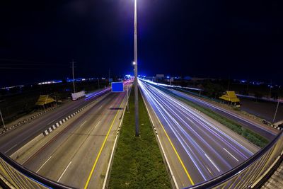 High angle view of light trails on highway at night