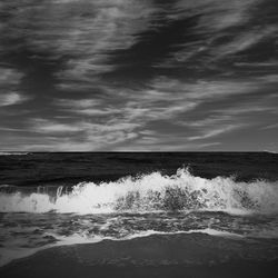 Scenic view of sea against cloudy sky