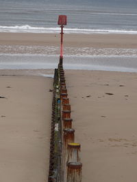 Traditional windmill on beach by sea