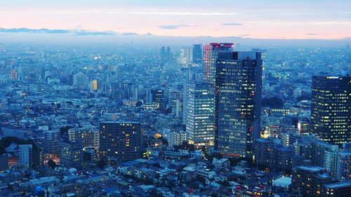 Cityscape against sky at dusk