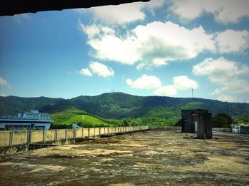 Scenic view of mountains against cloudy sky