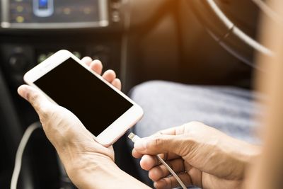 Midsection of man using mobile phone