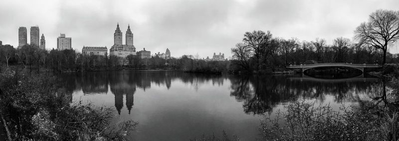 Panoramic view of lake and buildings against sky