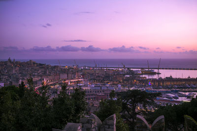 High angle view of townscape by sea against romantic sky