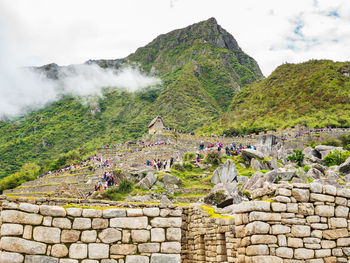 View of castle on mountain against cloudy sky