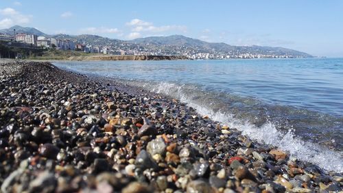 Pebbles on beach against sky