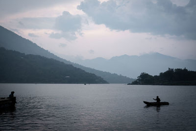 View of kayak and volcano in the distance seen from the lake atitlan surface in guatemala