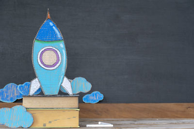 Close-up of toys on table against wall