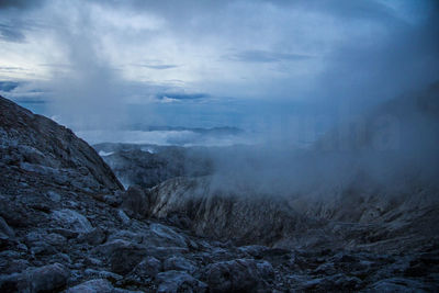 Rocky landscape against clouds