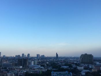 Cityscape against clear blue sky