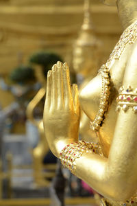 Cropped image of buddhist statue praying