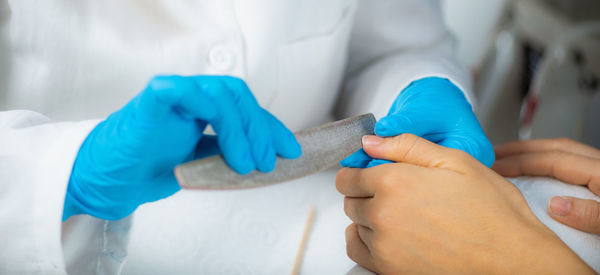 Close-up of woman hand holding finger