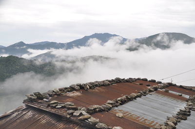 High angle view of buildings against cloudy sky