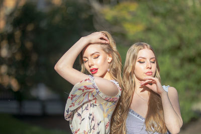 Beautiful friends standing in park