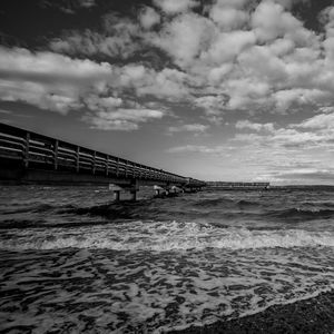 Bridge over sea against sky