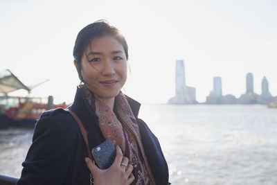 Young asian businesswoman looking in camera in urban environment