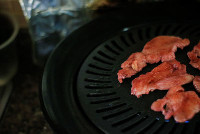 High angle view of meat on barbecue
