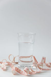 Close-up of drink on table against white background