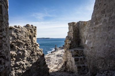 Scenic view of rocky beach against sky