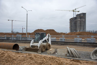 Bobcat skid-steer loader for loading and unloading works on city streets. 