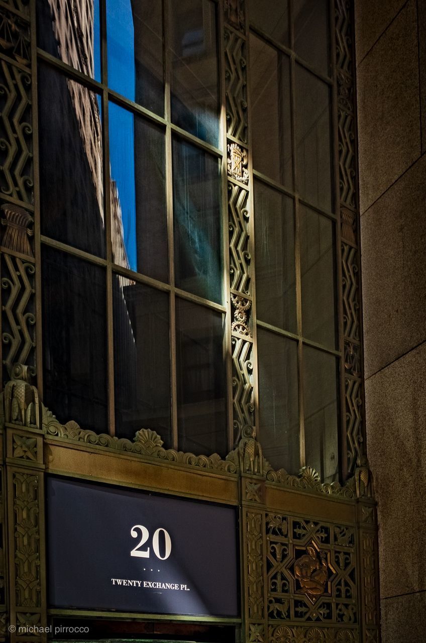 LOW ANGLE VIEW OF TEXT ON GLASS BUILDING