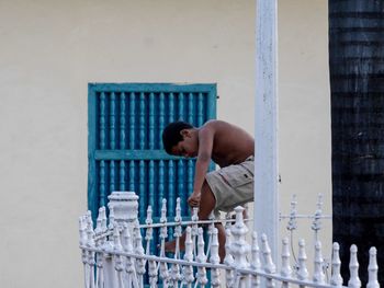 Boy standing by railing