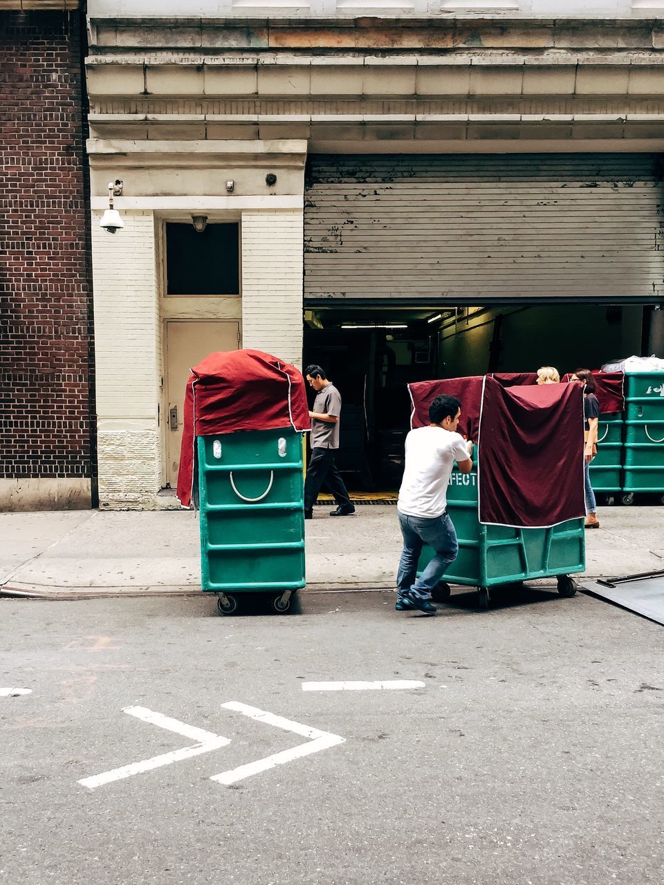 street, building exterior, built structure, architecture, rear view, men, sidewalk, full length, city, walking, person, lifestyles, sunlight, day, city life, outdoors, transportation
