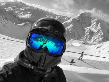 Close-up of ski lift against snowcapped mountains