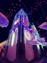 Low angle view of illuminated ferris wheel at night