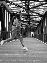 Side view of woman running on footpath