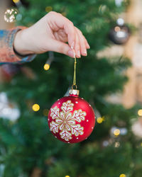 Cropped hand of woman holding bauble