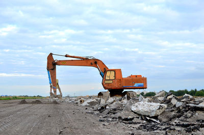 Construction site by road against sky