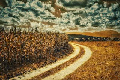 Empty road passing through landscape