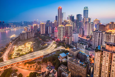 High angle view of city lit up at night