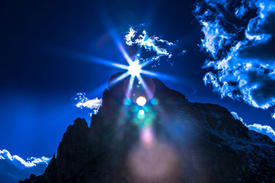 Low angle view of illuminated tree against sky at night