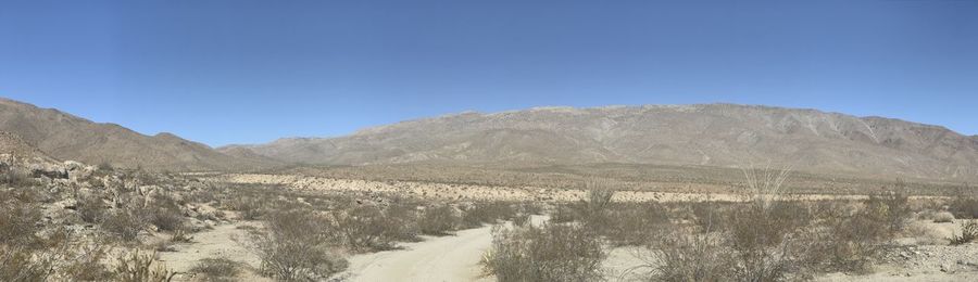 Scenic view of mountains against clear blue sky