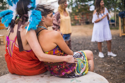 Female friends sitting at park