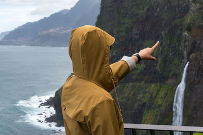 Rear view of person standing in mountains