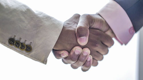 Close-up of hands holding text over white background