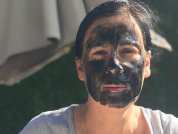 Close-up portrait of woman with painted face