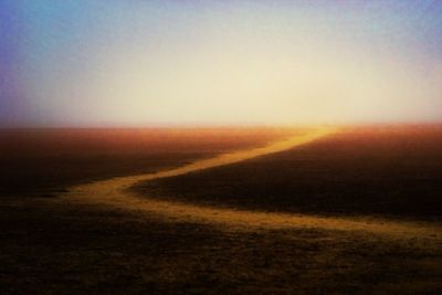 Scenic view of landscape against sky at sunset