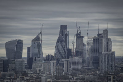 View of skyscrapers against cloudy sky