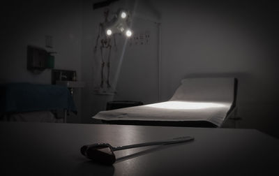 Illuminated electric lamp on table at home