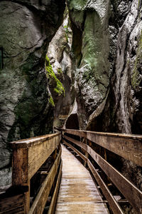 Footbridge over rocks amidst trees