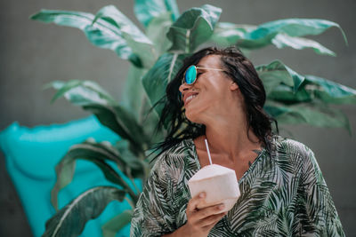 Midsection of a woman holding drink